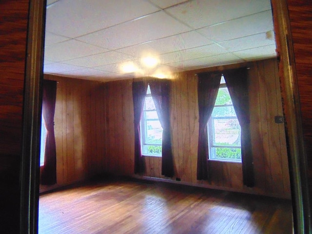 208 Tyler St, Athens, PA 18810 - empty room with a paneled ceiling, wood finished floors, and wood walls