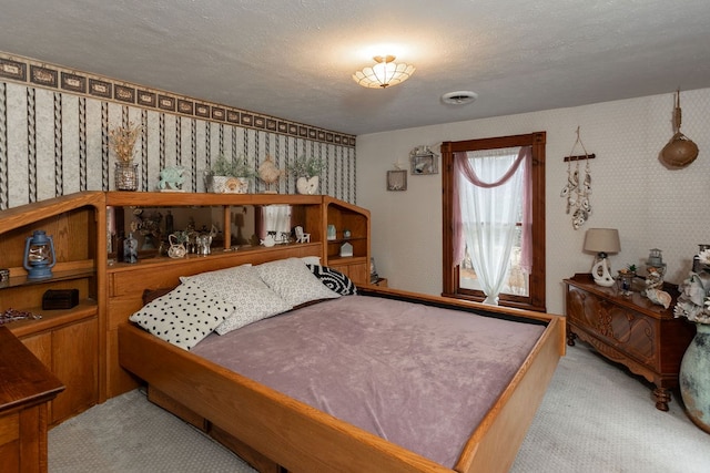 carpeted bedroom featuring a textured ceiling