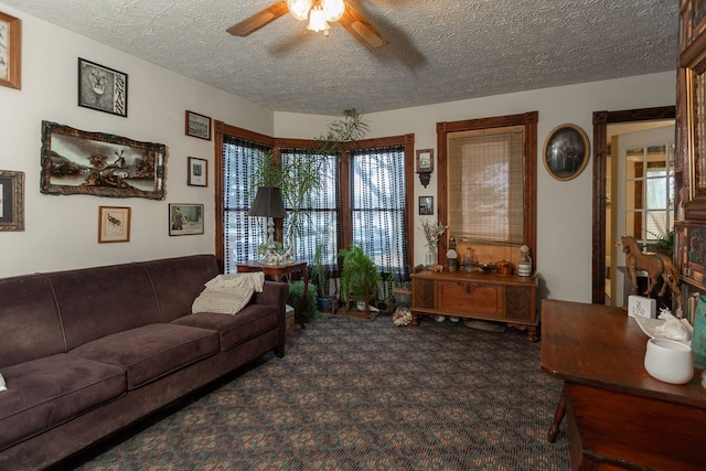 carpeted living room with a textured ceiling and ceiling fan