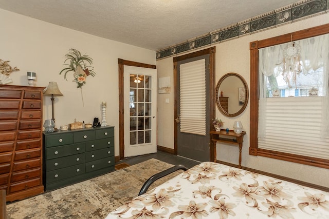 bedroom featuring a textured ceiling and a notable chandelier