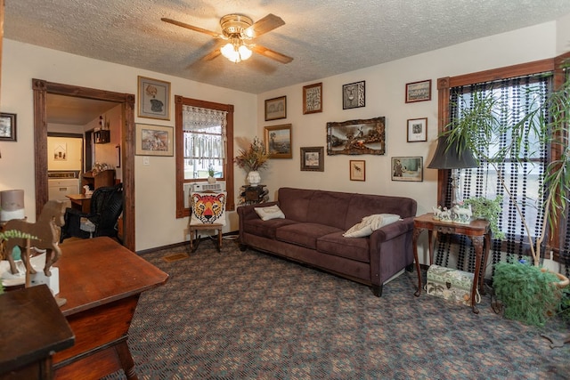 living room with a textured ceiling, plenty of natural light, and ceiling fan