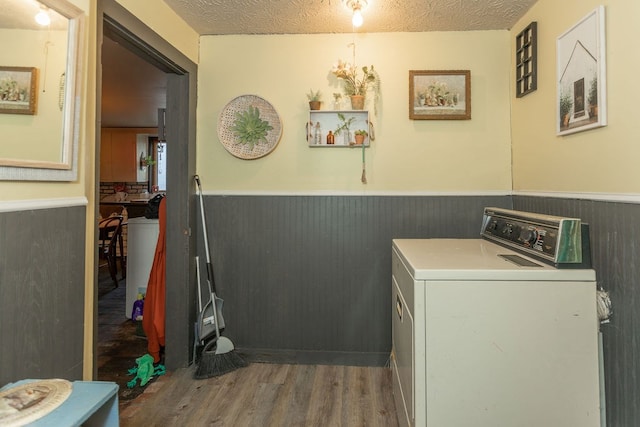 washroom featuring washer / clothes dryer, wood-type flooring, and a textured ceiling