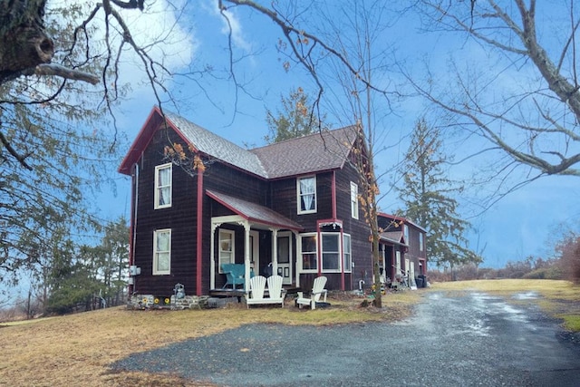 view of front of home with a porch and a front lawn