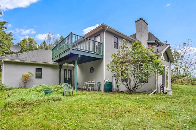 743 Stone Rd, Westfield, PA 16950 - back of house featuring a shingled roof, a deck, a yard, a chimney, and stucco siding