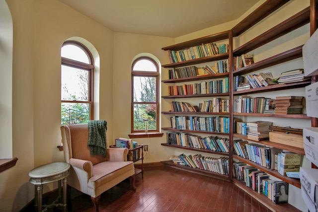743 Stone Rd, Westfield, PA 16950 - sitting room featuring wall of books, baseboards, and hardwood / wood-style floors