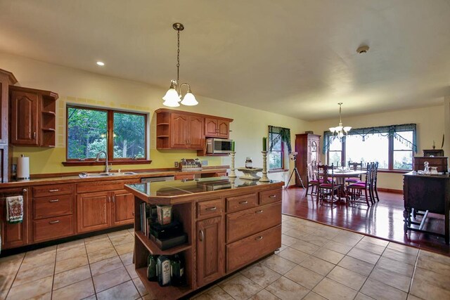 743 Stone Rd, Westfield, PA 16950 - kitchen with stainless steel microwave, a chandelier, light tile patterned floors, open shelves, and a sink