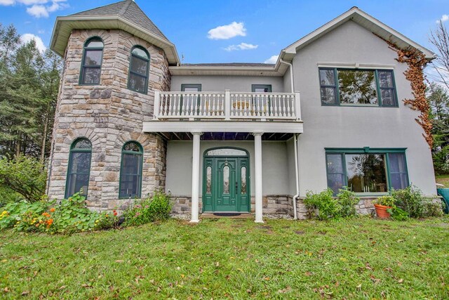 743 Stone Rd, Westfield, PA 16950 - view of front facade with a front lawn, stone siding, a balcony, and stucco siding