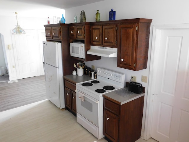 kitchen featuring dark brown cabinetry, light hardwood / wood-style flooring, pendant lighting, and white appliances