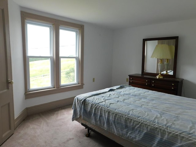 bedroom featuring light carpet