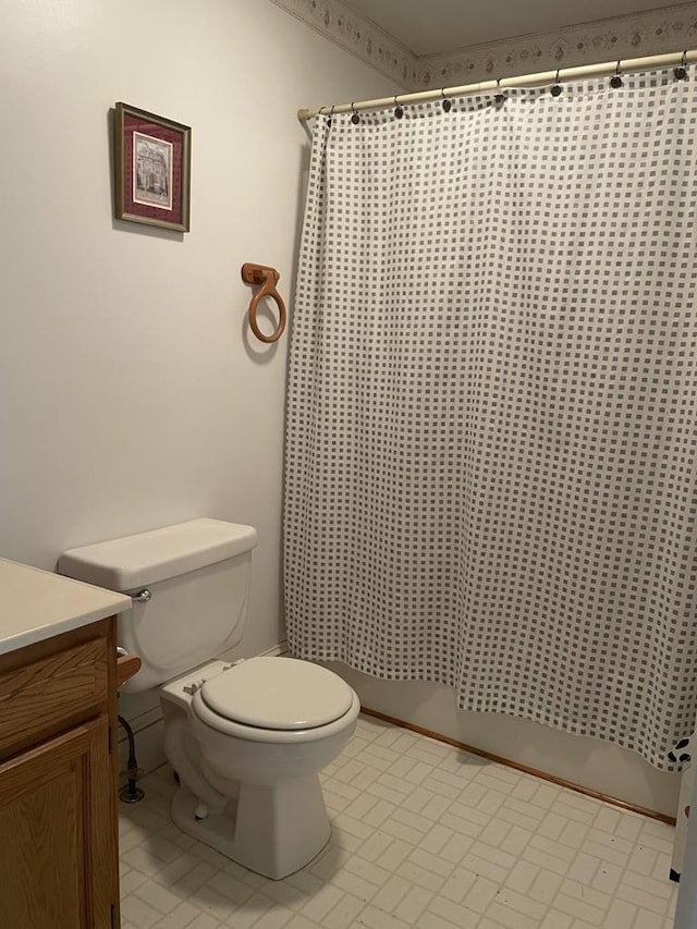 bathroom with tile patterned floors, vanity, toilet, and curtained shower