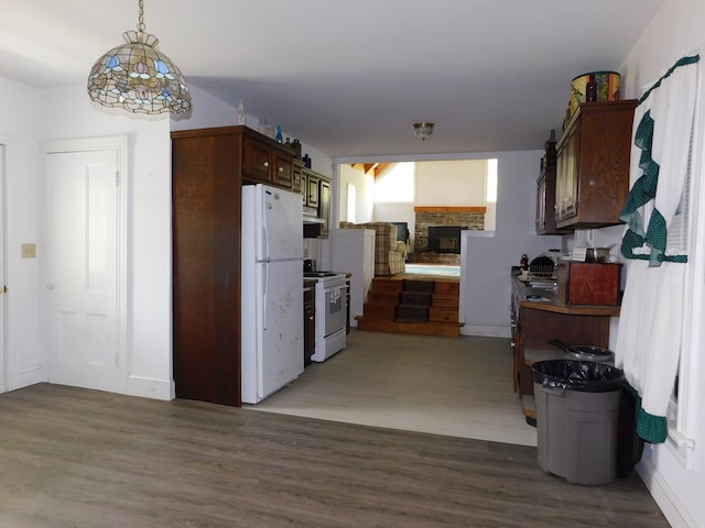 kitchen featuring a fireplace, dark brown cabinets, white appliances, and hardwood / wood-style flooring