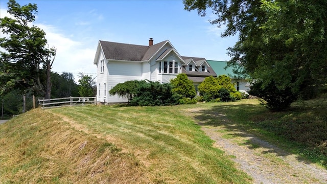 view of property exterior with a yard