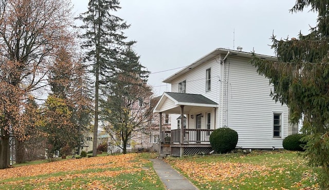 view of home's exterior featuring a lawn and a porch