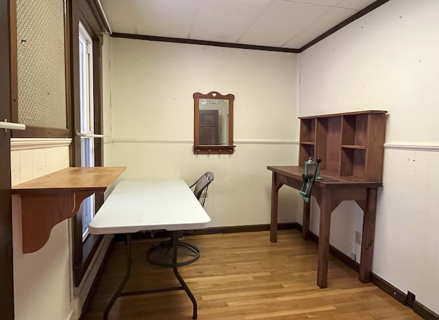 home office with light hardwood / wood-style floors and crown molding