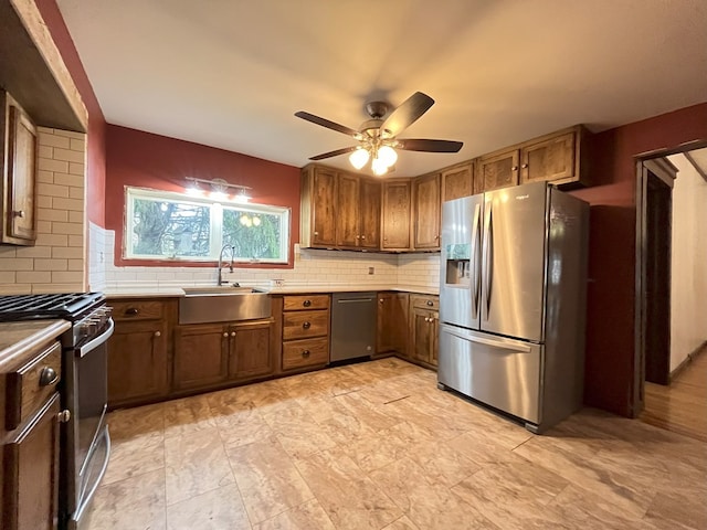 kitchen featuring backsplash, stainless steel appliances, ceiling fan, and sink