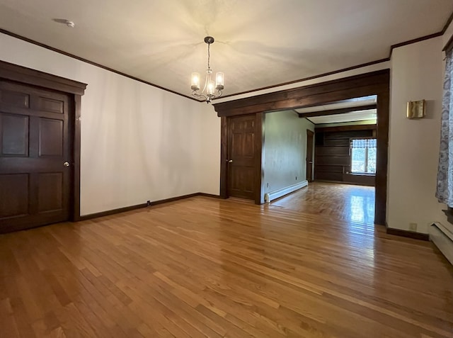 unfurnished dining area featuring a chandelier, hardwood / wood-style floors, a baseboard heating unit, and crown molding