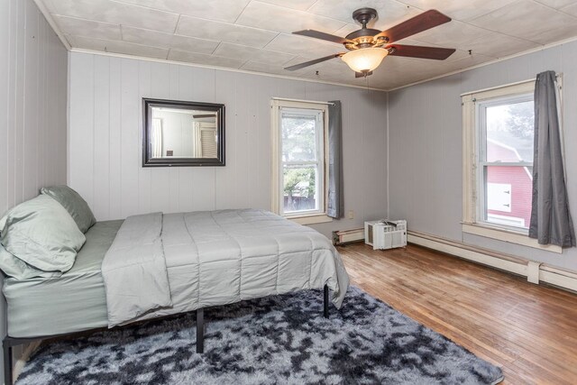 11 Purple St, Wellsboro, PA 16901 - bedroom featuring multiple windows, wood finished floors, baseboard heating, and ceiling fan