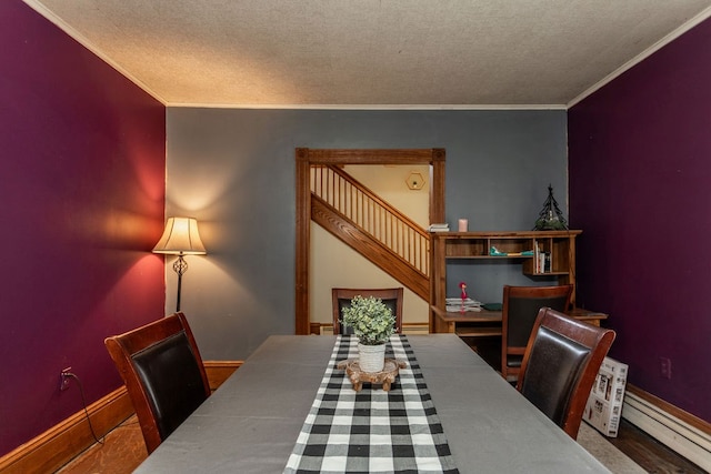 11 Purple St, Wellsboro, PA 16901 - dining space with a textured ceiling, a baseboard heating unit, and ornamental molding
