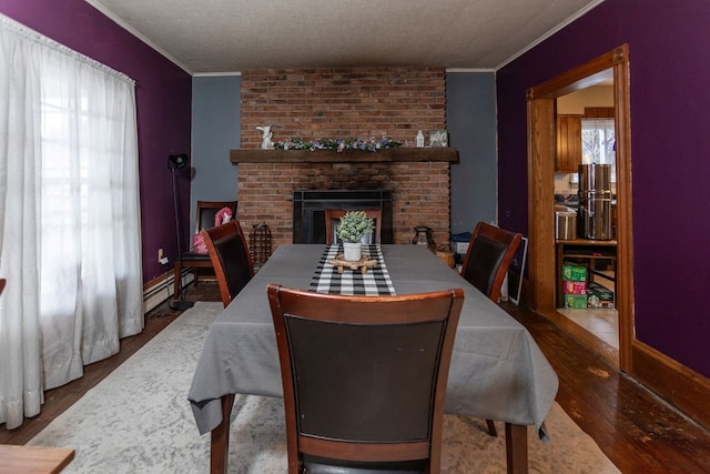11 Purple St, Wellsboro, PA 16901 - dining space with ornamental molding, a fireplace, a healthy amount of sunlight, and hardwood / wood-style floors