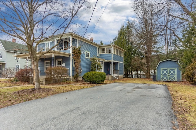 11 Purple St, Wellsboro, PA 16901 - view of front facade featuring a porch, a storage unit, an outbuilding, and a chimney