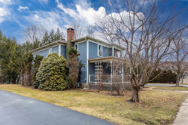 11 Purple St, Wellsboro, PA 16901 - view of side of property with a porch, a yard, and a chimney