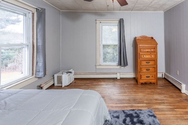11 Purple St, Wellsboro, PA 16901 - bedroom featuring wood finished floors, a ceiling fan, and a baseboard radiator