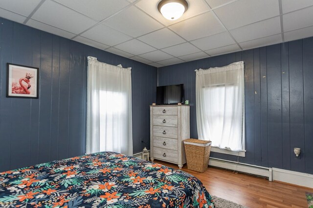 11 Purple St, Wellsboro, PA 16901 - bedroom featuring a baseboard radiator, a paneled ceiling, wood finished floors, and a baseboard heating unit