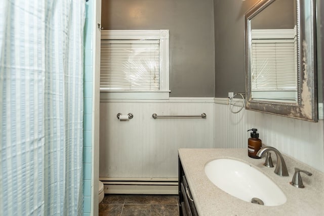 11 Purple St, Wellsboro, PA 16901 - full bath with a wainscoted wall, a shower with curtain, toilet, a baseboard radiator, and vanity