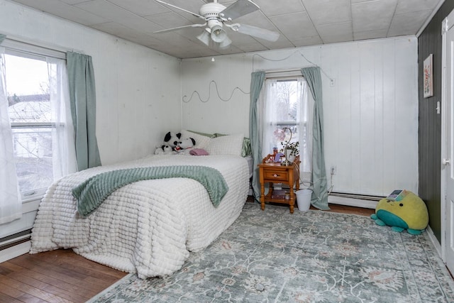11 Purple St, Wellsboro, PA 16901 - bedroom with baseboard heating, a ceiling fan, and wood finished floors