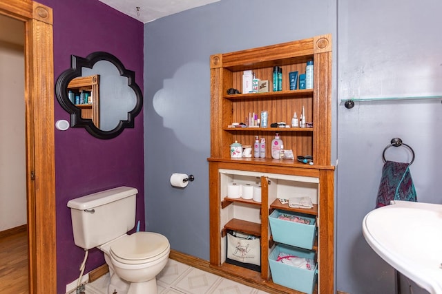 11 Purple St, Wellsboro, PA 16901 - bathroom with toilet, baseboards, and a sink