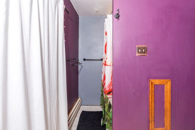 11 Purple St, Wellsboro, PA 16901 - bathroom with a shower with shower curtain, tile patterned floors, and baseboard heating