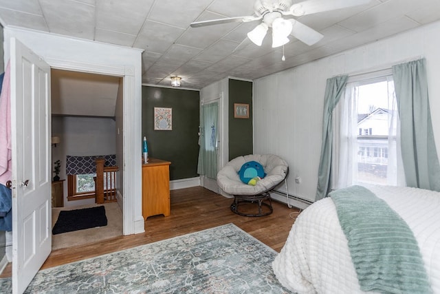 11 Purple St, Wellsboro, PA 16901 - bedroom featuring baseboards, a baseboard heating unit, a ceiling fan, and wood finished floors