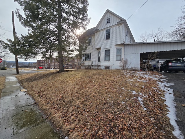 view of side of home featuring a carport