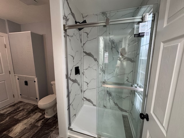 full bath featuring a marble finish shower and toilet