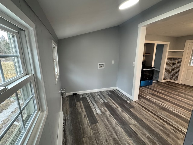 clothes washing area featuring washer hookup, dark wood finished floors, and baseboards