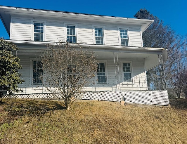 exterior space featuring a porch and a lawn