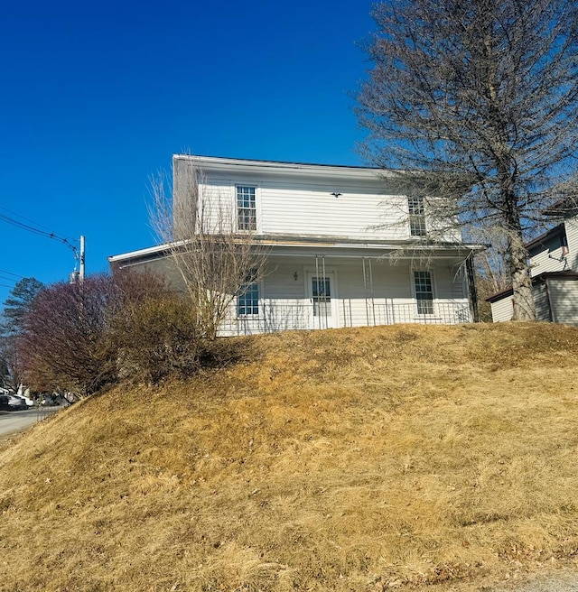 rear view of property featuring a porch