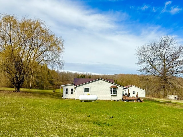 view of property exterior featuring a wooden deck and a lawn