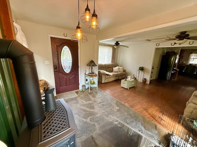 entrance foyer with plenty of natural light, a ceiling fan, and wood finished floors