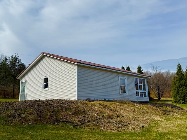 view of property exterior featuring metal roof