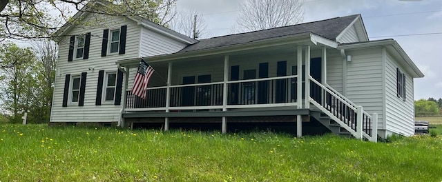 rear view of house featuring covered porch