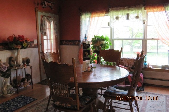 177 Old Barton Rd, Barton, NY 13734 - dining room with a baseboard radiator, wainscoting, and wood finished floors