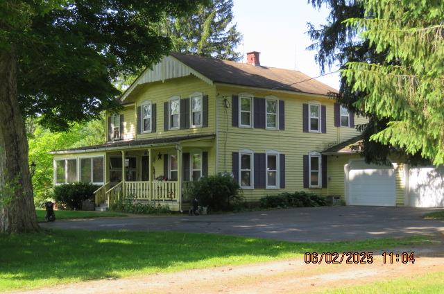 177 Old Barton Rd, Barton, NY 13734 - view of front of house with a porch, driveway, a chimney, a garage, and a front yard