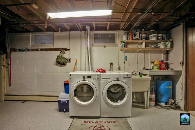 washroom with separate washer and dryer and sink