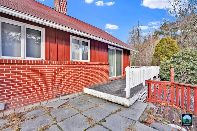 view of property exterior with a wooden deck