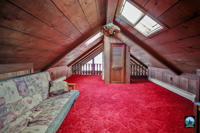 bonus room featuring lofted ceiling with skylight, wooden walls, a baseboard radiator, carpet floors, and wooden ceiling