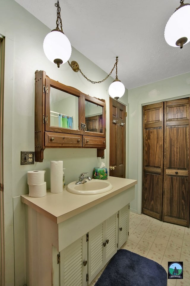 bathroom featuring vanity and a textured ceiling