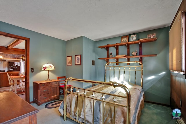 bedroom featuring a textured ceiling and carpet