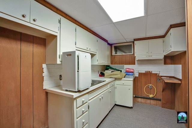 kitchen featuring decorative backsplash, a paneled ceiling, and white refrigerator