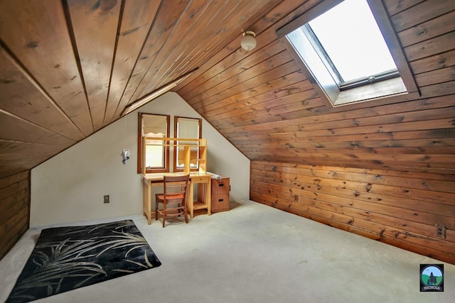 additional living space with lofted ceiling with skylight, carpet, wooden walls, and wood ceiling